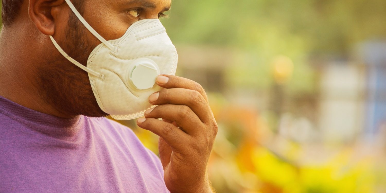 asian-man-wearing-the-face-mask-due-to-air-pollution-young-adult-on-picture-id1185641653